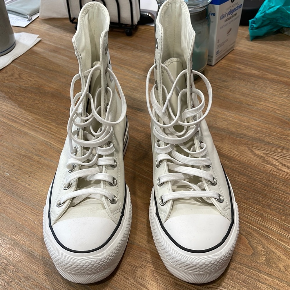 Converse leather high tops.